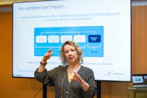Jacqueline Scheidsbach van Impact Centre Erasmus geeft uitleg over de weg van maatschappelijke ambities naar echt impact maken.